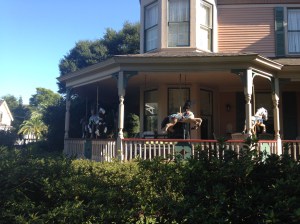 Carousel horses on a verandah